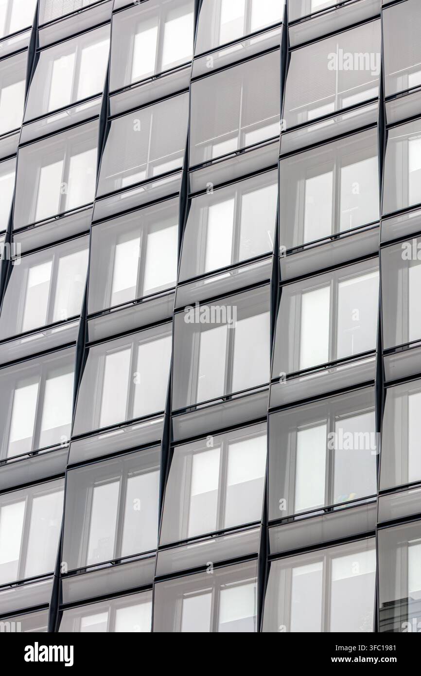 Vertical glass facade with repeated windows. Modern architecture pattern. Stock Photo