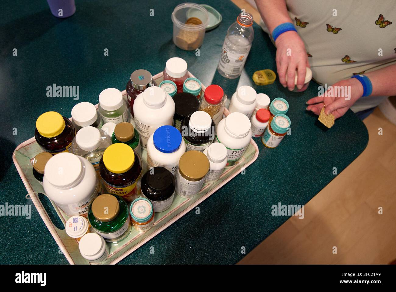 Tracy Rand takes her morning medications and supplements to help with ...