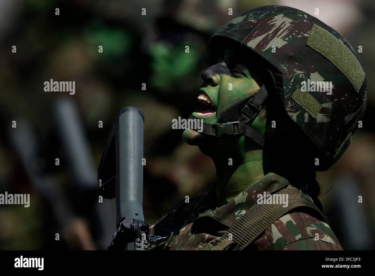 A soldier sings Brazil's national anthem during a parade marking ...