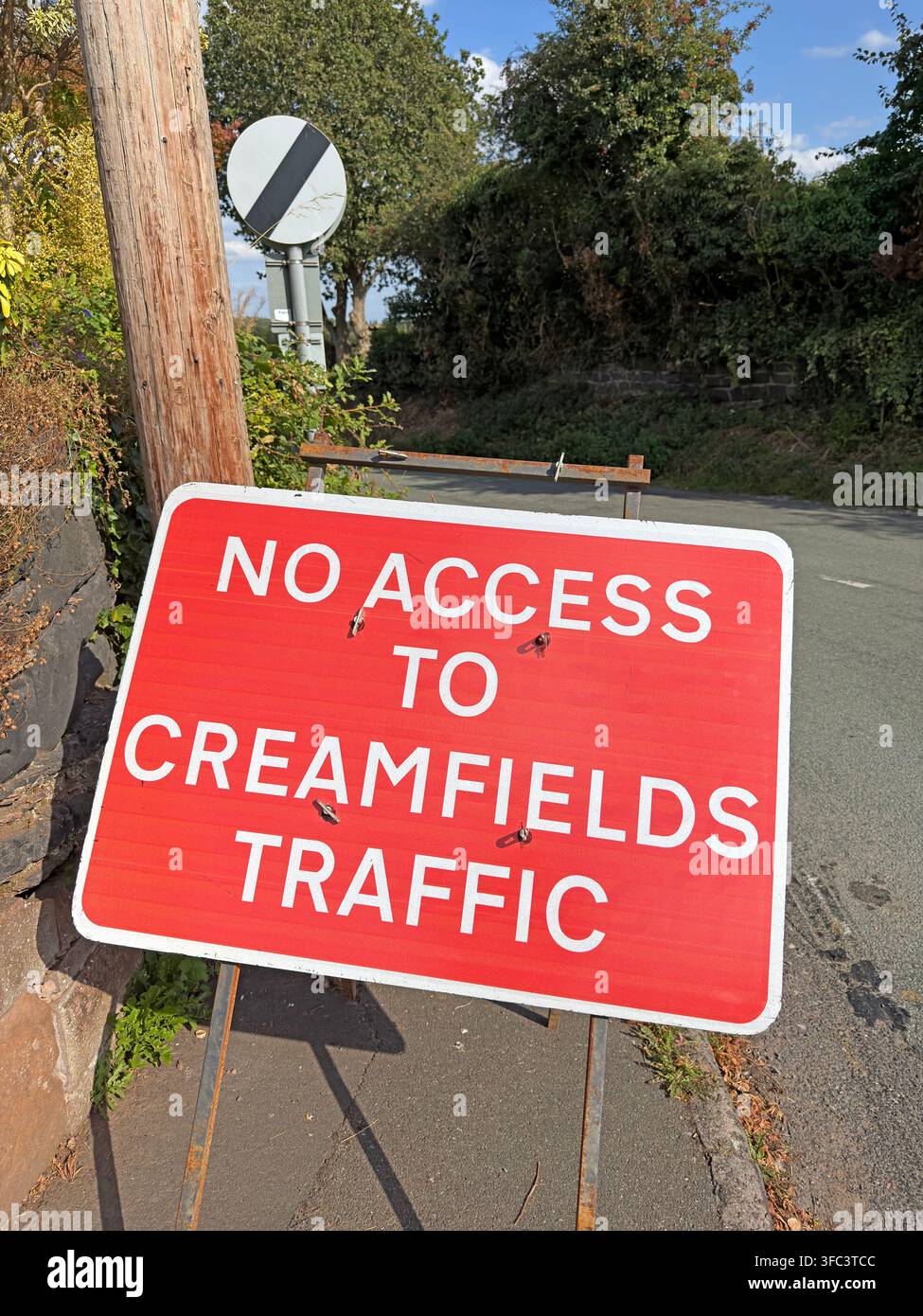 Red 'No Access to Creamfields Traffic' sign on a narrow rural lane at Daresbury, Cheshire, protecting local roads during the 2026 festival. Stock Photo