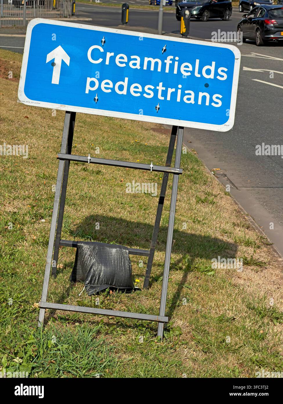 Freestanding Creamfields pedestrians sign on a grass verge at Daresbury, Cheshire, guiding festivalgoers during the 2026 event. Stock Photo
