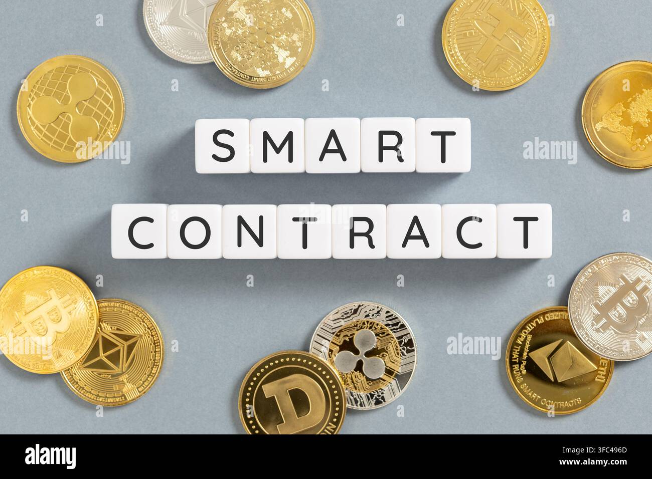 smart contract text on blocks surrounded by cryptocurrency coins Stock Photo