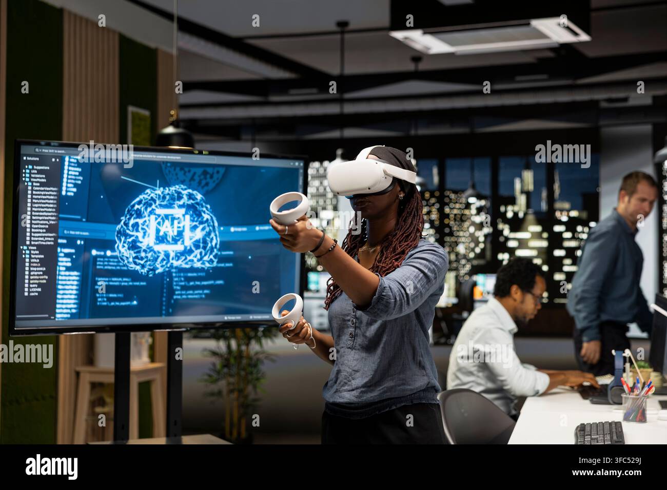 Programmer in tech startup office using VR headset and AI to automate repetitive tasks. Worker using virtual reality and artificial intelligence to speed up feature implementation Stock Photo