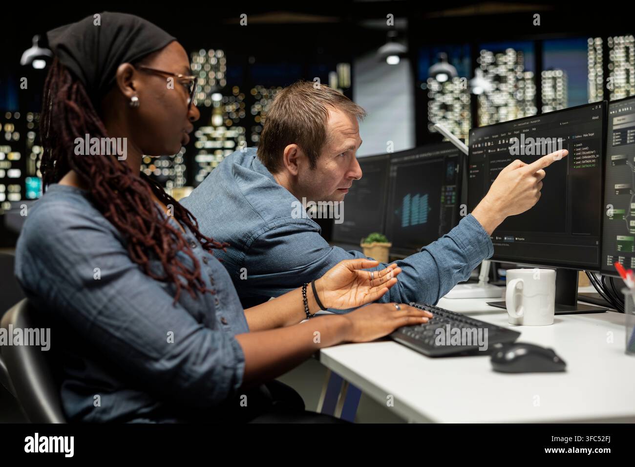 Manager assisting tech startup software developer coding AI algorithms during internship. Supervisor overseeing work done by woman in office using deep learning models to do automation Stock Photo