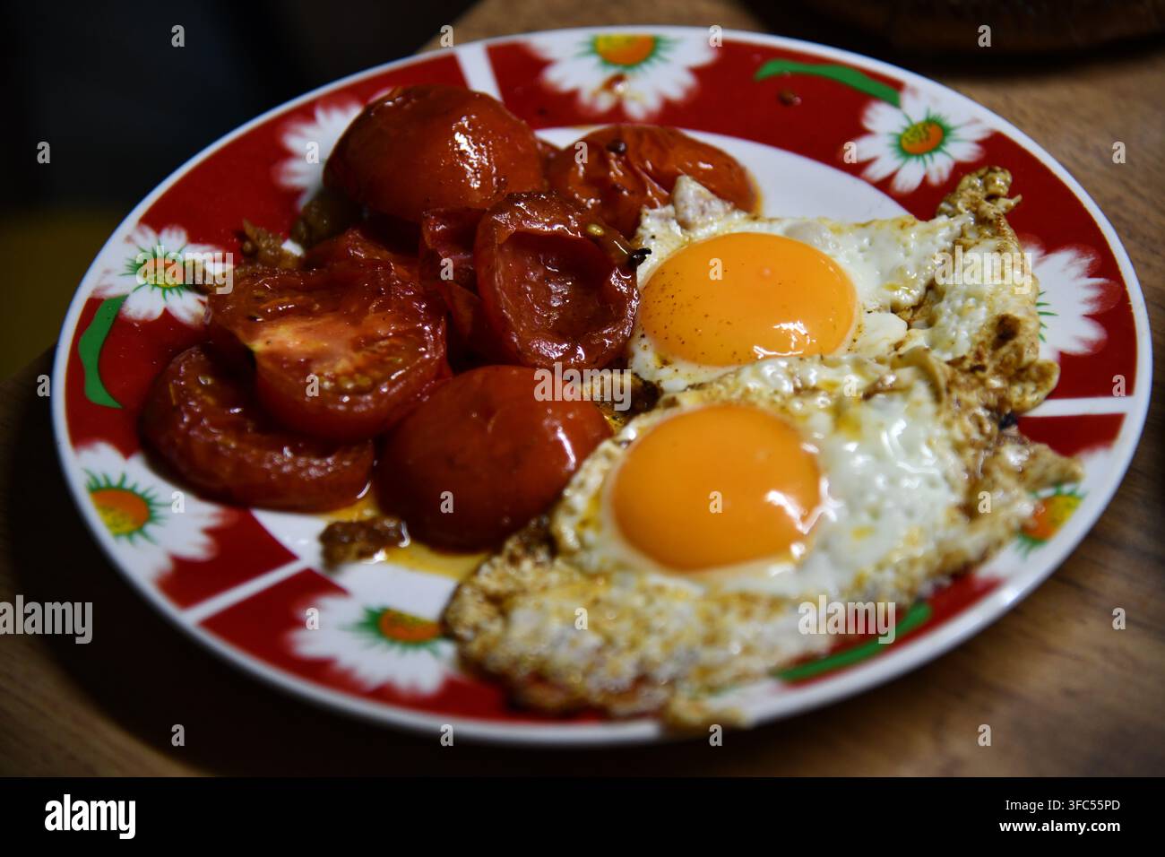 Scrambled eggs on white plate over white wooden background. Stock Photo