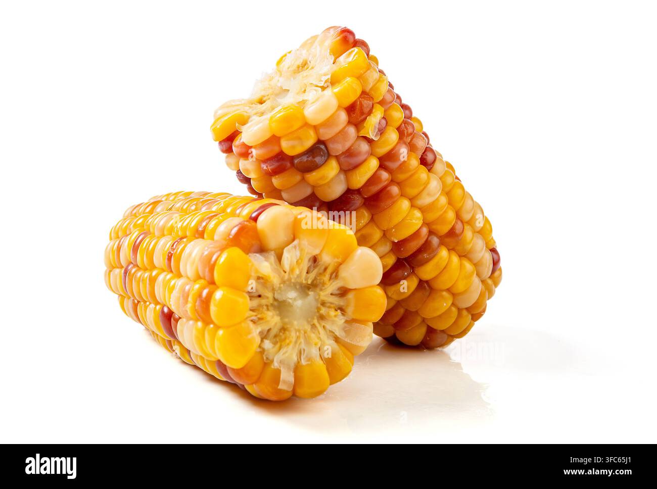 Boiled multicolored waxy corn cobs and cut segments isolated on white background Stock Photo