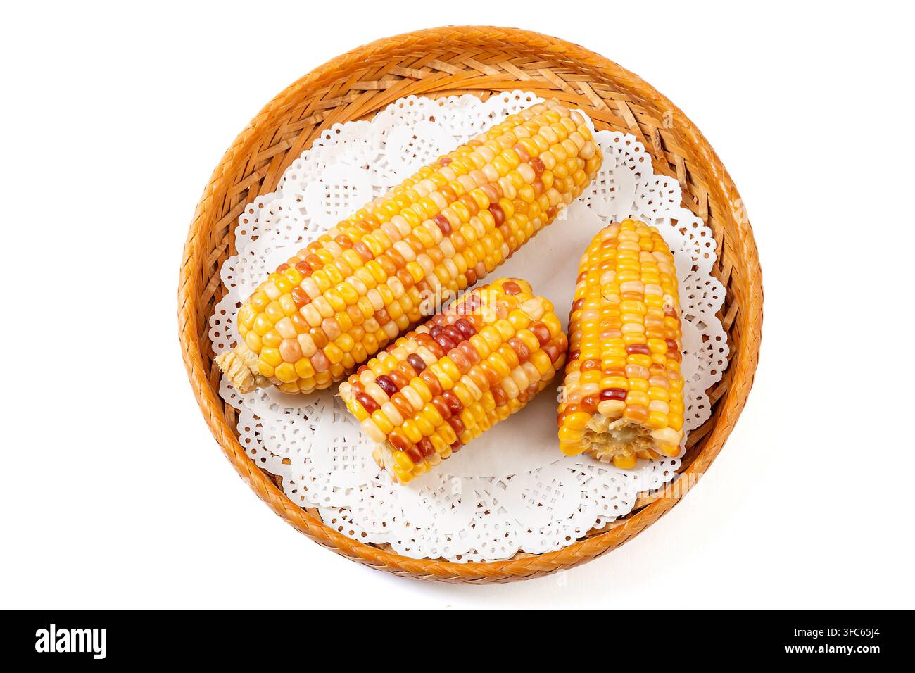 Boiled multicolored waxy corn cobs and cut segments isolated on white background Stock Photo