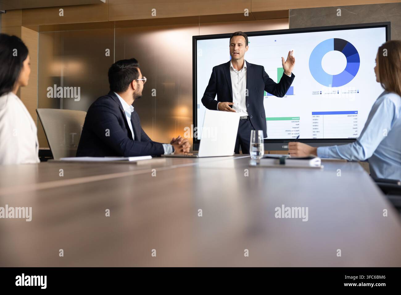 Businessman presenting financial data displayed on screen Stock Photo