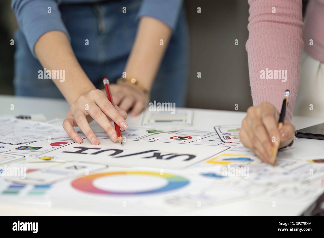 Two designers attended a joint UX and UI design session, outlined ideas and discussed user experience improvements Stock Photo