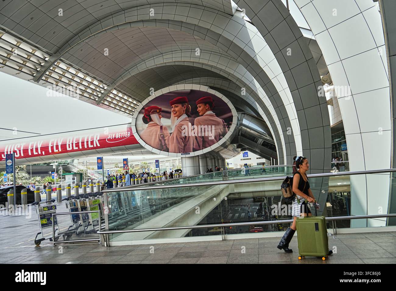 A traveler walks outside Terminal 3 at Dubai International Airport in ...