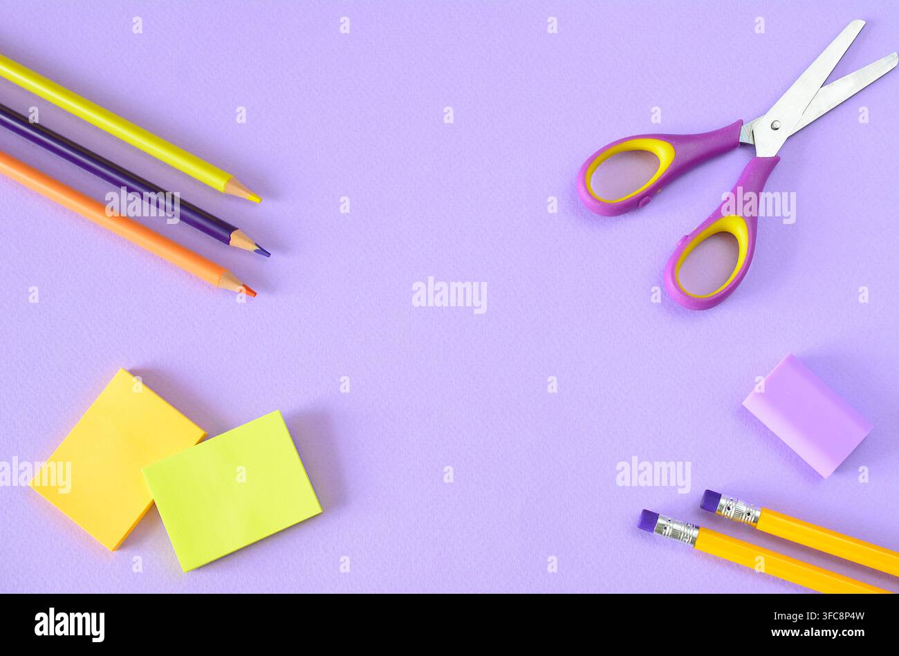 School Supplies Arranged on Purple Background, multicolored supplies, copy space, flat lay Stock Photo