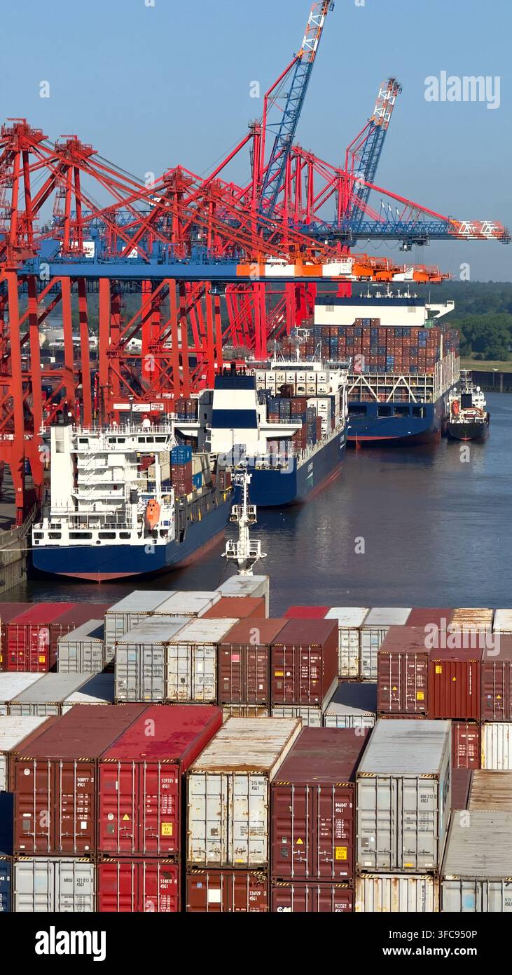 Container ships and gantry cranes at a busy cargo terminal with shipping containers in the foreground - Smartphone Captured Stock Image