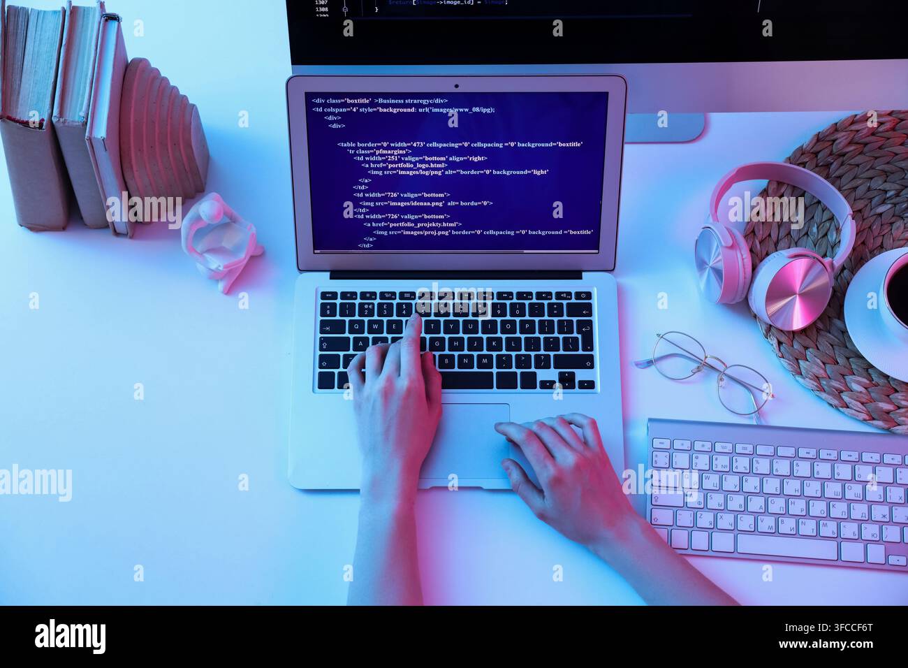 Female programmers hands working with laptop on table, top view Stock Photo