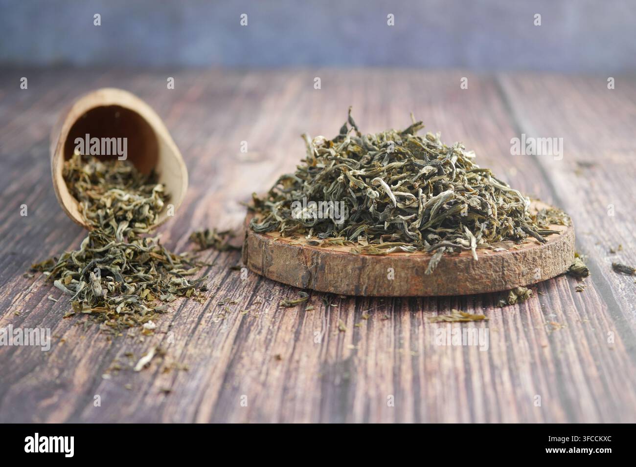 Dried tea leaves placed on a wooden surface Stock Photo