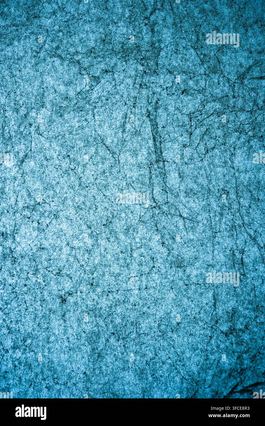 Abstract blue textured wall or painted surface with scratches, cracks and mottled marks, suitable as a grunge background Stock Photo
