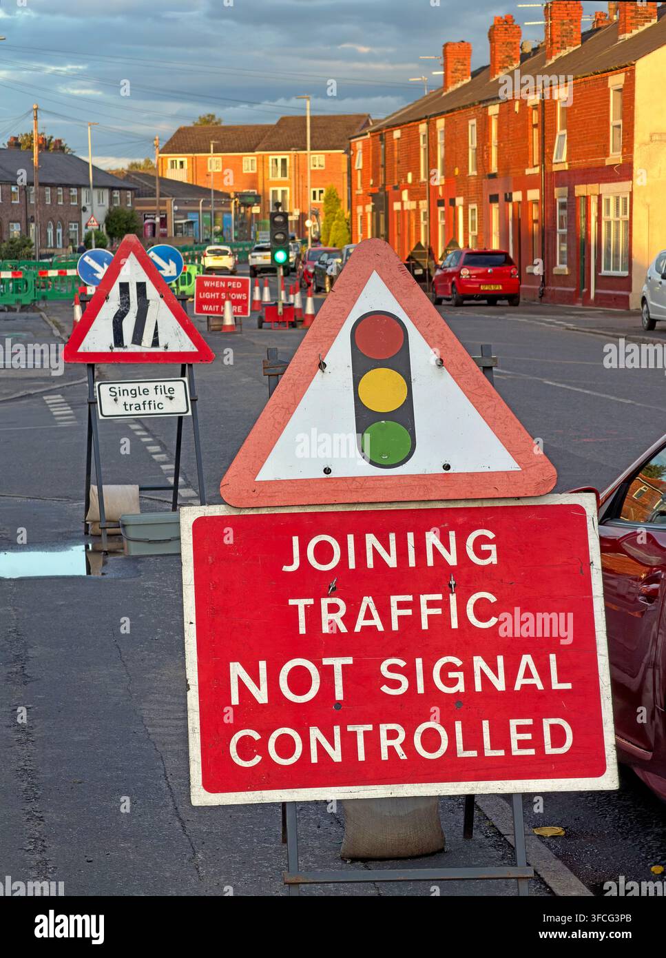 Temporary roadworks sign reading Joining Traffic Not Signal Controlled in Latchford, Warrington Stock Photo