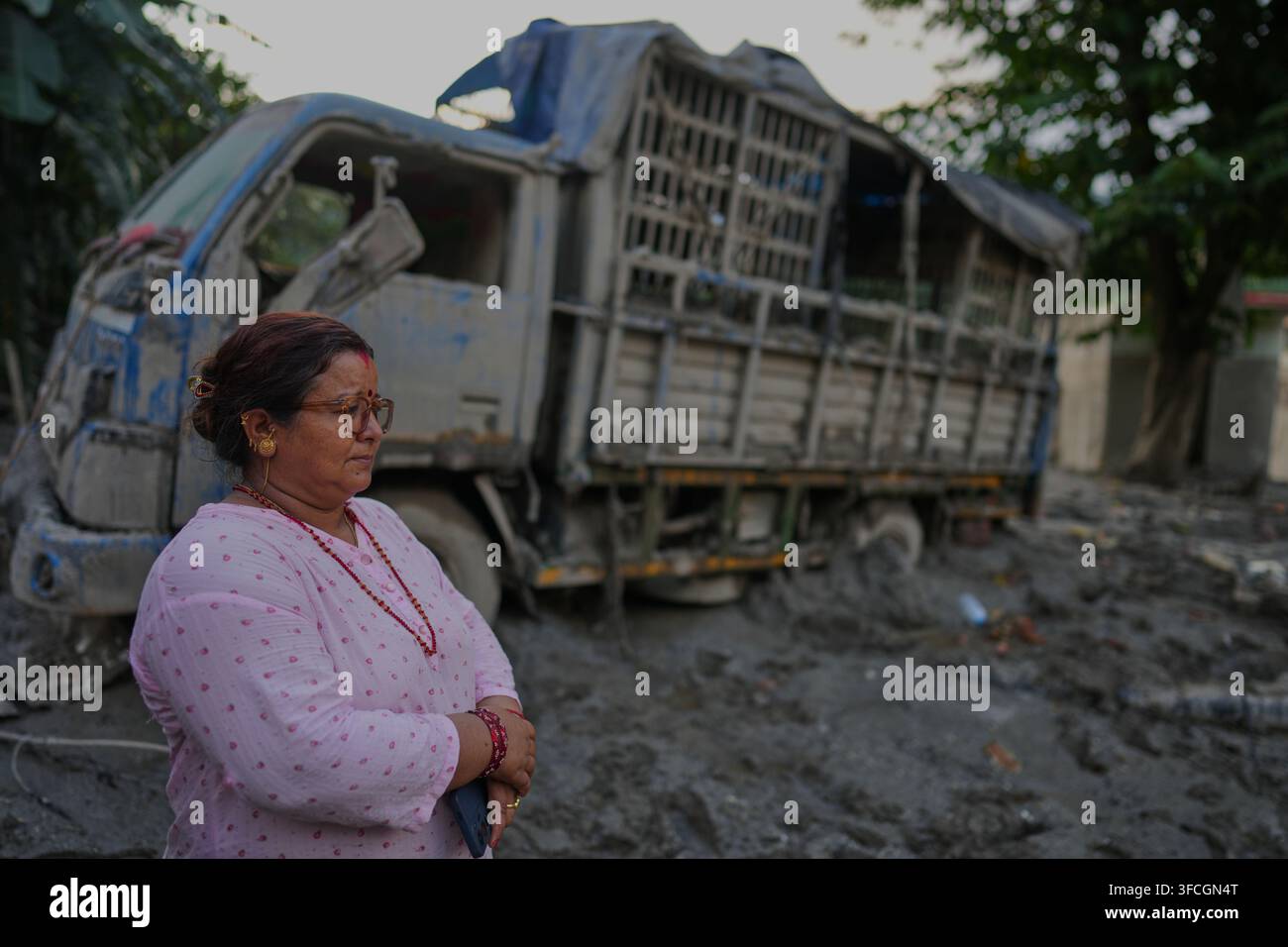 A resident stands amidst the devastation left by flash flooding in ...