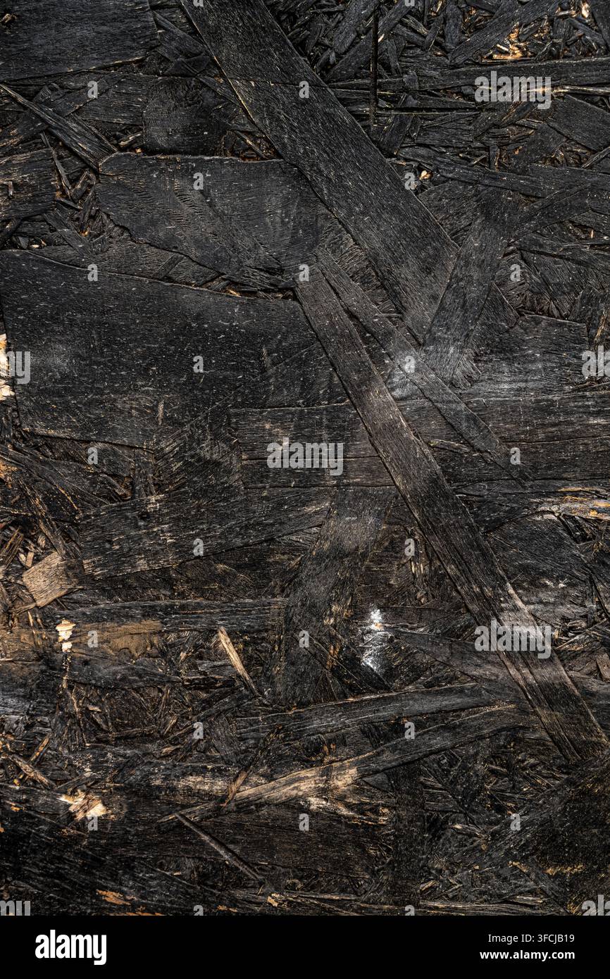 Black painted oriented strand board OSB wood texture. Stock Photo