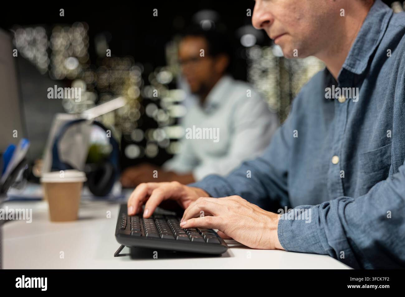 Close up of software developer typing on PC keyboard in startup office, optimizing code for performance and scalability, doing quality assurance. Man Stock Photo