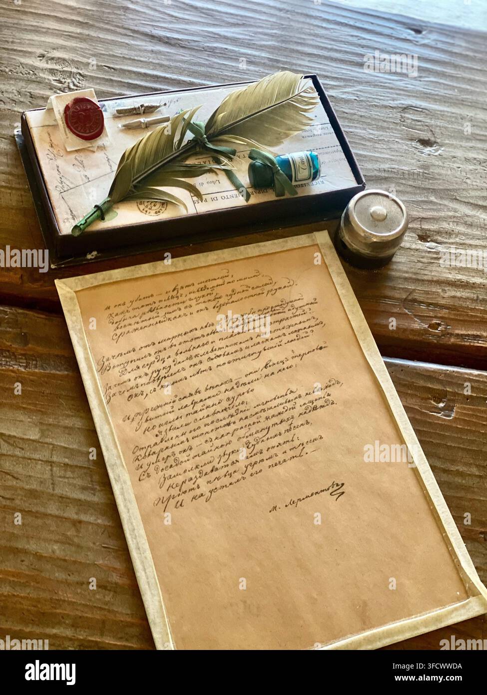Taman, Russia- July 13 2022: Historic writing display with quill pens, ink bottles and handwritten manuscript - Smartphone Captured Stock Image