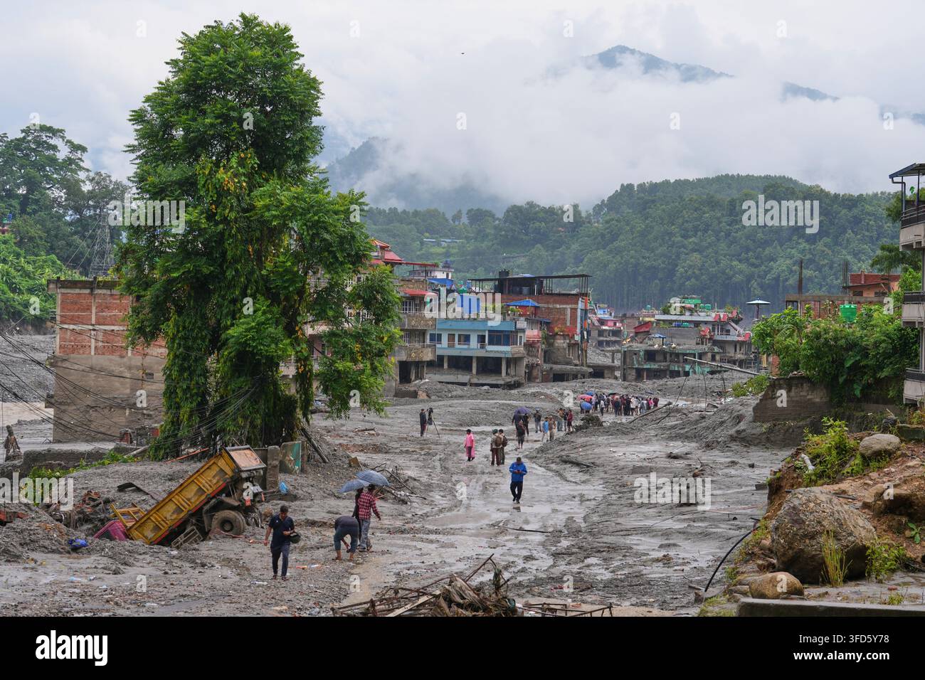 Residents return to their houses to assess the damage following flash flooding in Nuwakot district in Nepal, Saturday, Aug. 29, 2026. (AP Photo/Rajesh Kumar Singh) Stock Photo