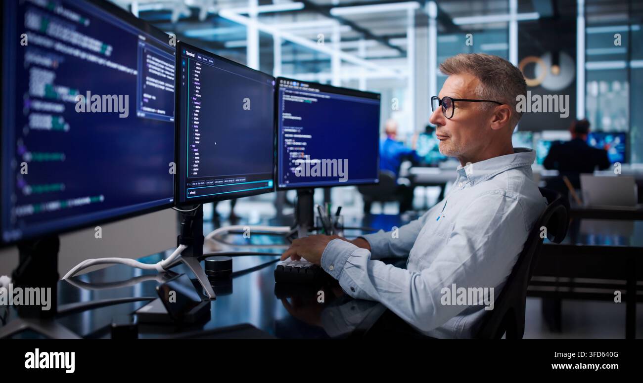 Software Developer Carefully Debugging Code Using Cloud-based Programming Tools. Stock Photo