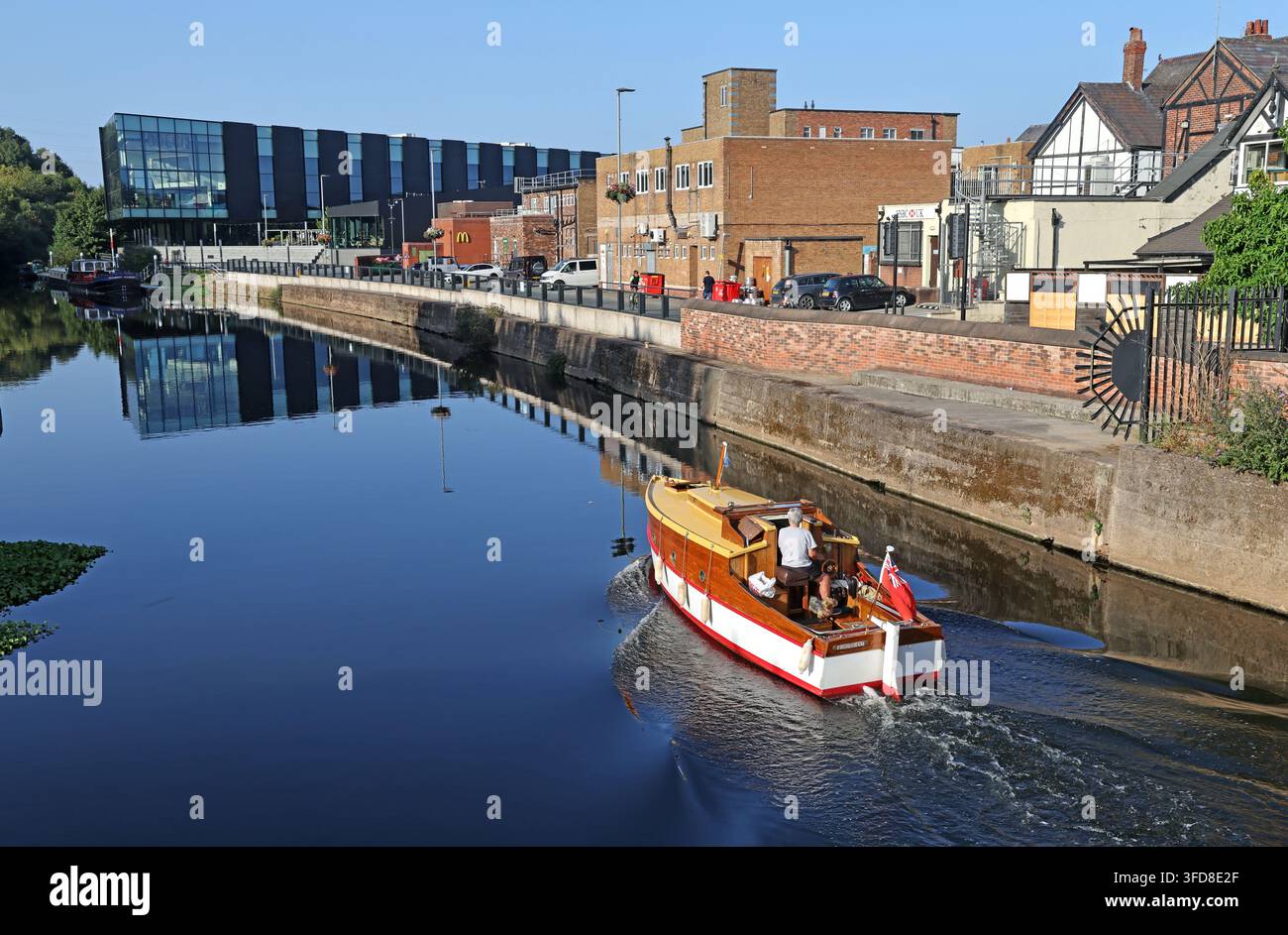 Small sailing craft travelling along the River Weaver near Frodsham, Cheshire. Stock Photo