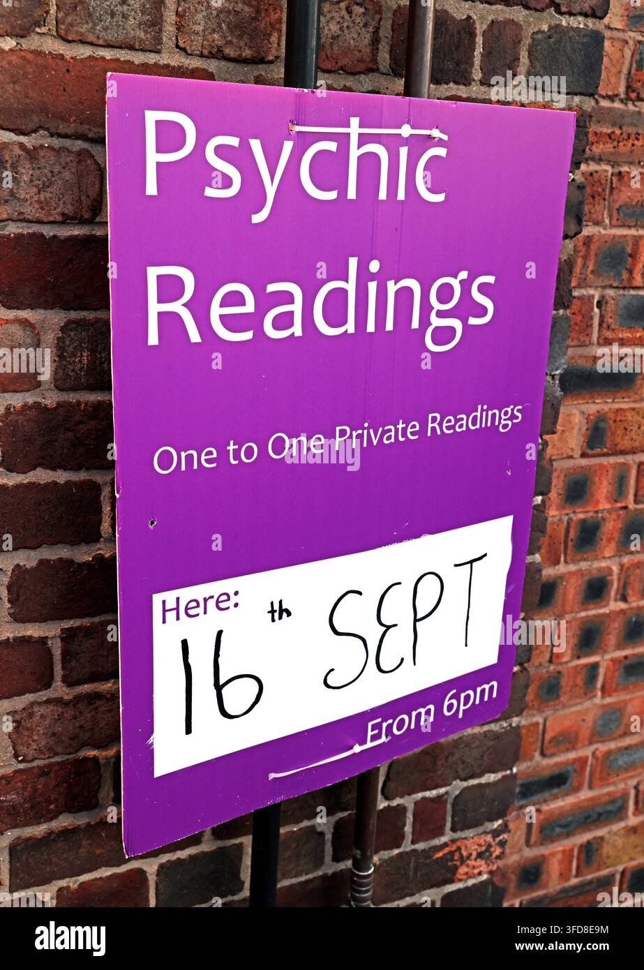 Pub sign advertising private psychic readings on a September evening. Stock Photo