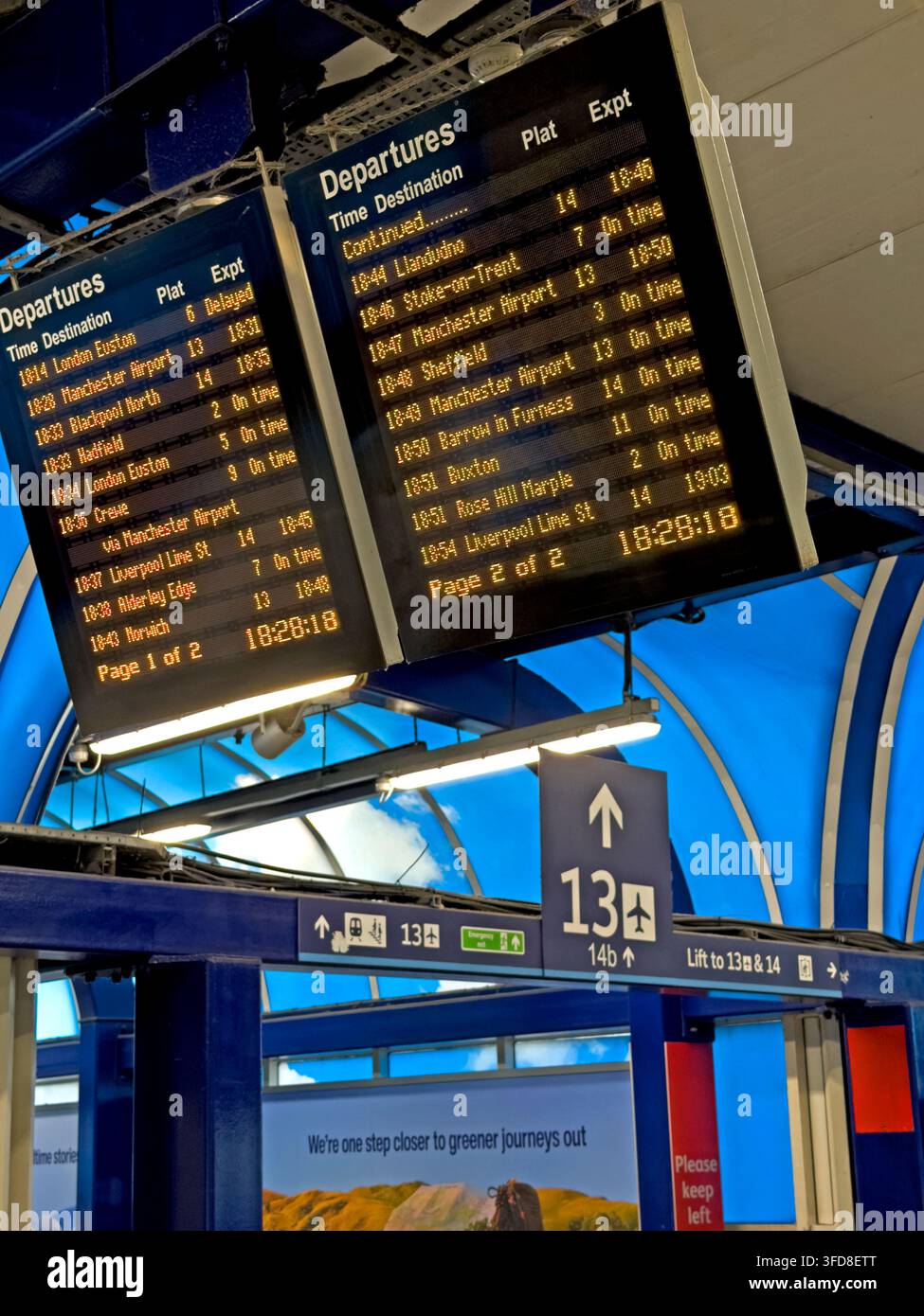 Electronic departure board above Manchester Piccadilly platforms 13 and 14. Stock Photo