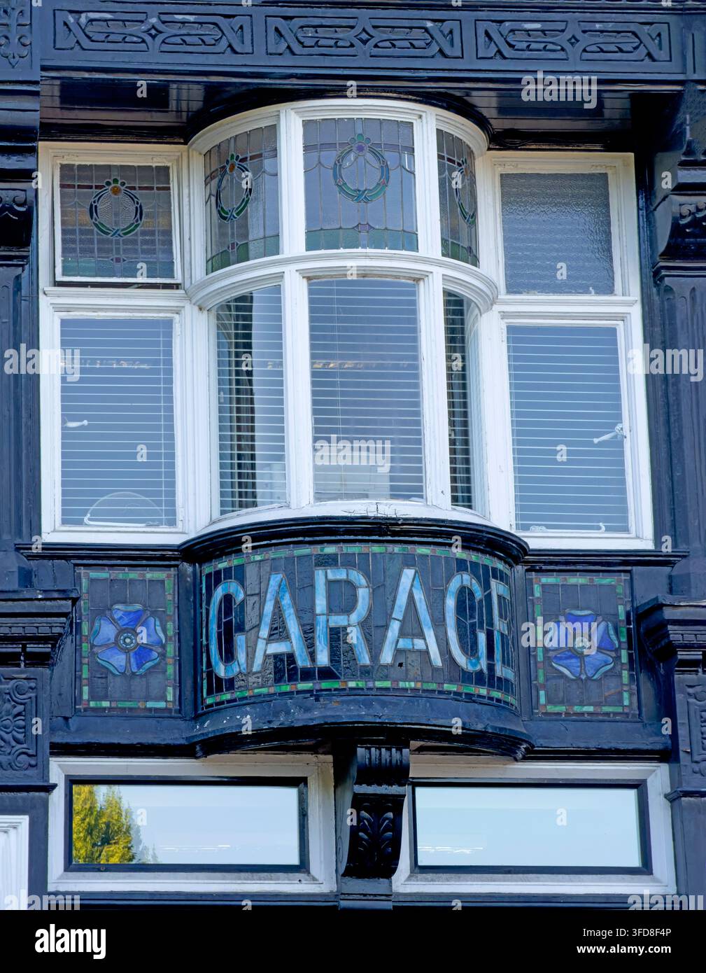 Historic tiled “GARAGE” frontage and stained-glass bay window on the former Bridge Inn, Castle Street, Northwich. Stock Photo