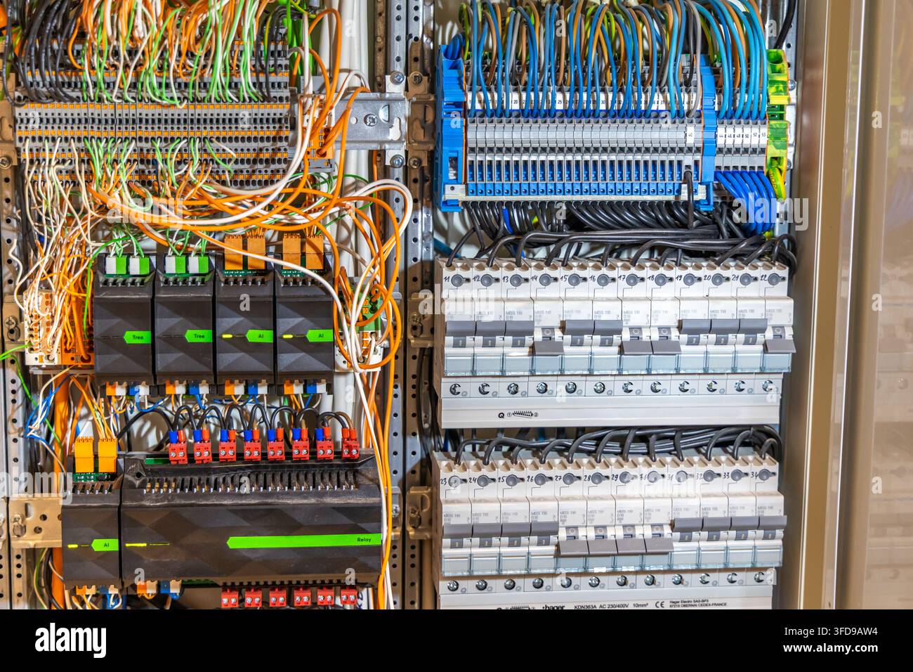 A detailed view of an industrial electrical control panel showcasing intricate wiring and multiple circuit breakers for power distribution Stock Photo