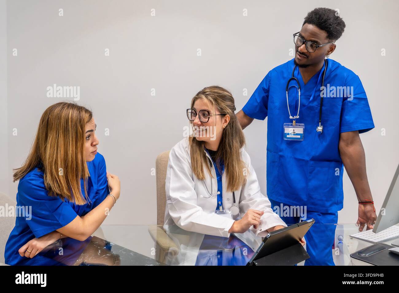 Medical team collaborating and discussing patient data Stock Photo
