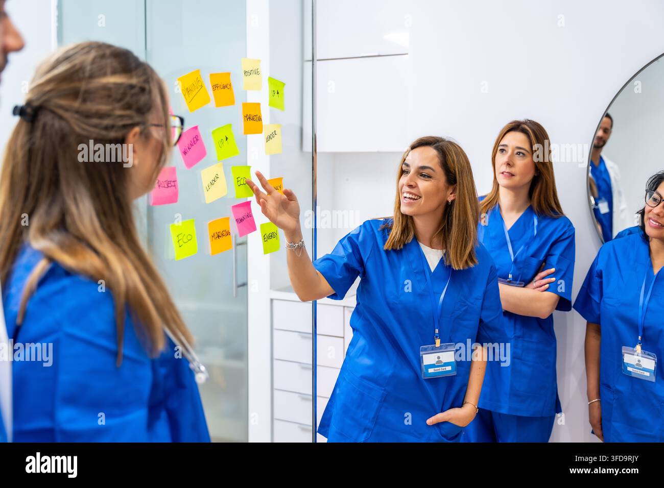 Medical professionals collaborating on strategy using sticky notes Stock Photo