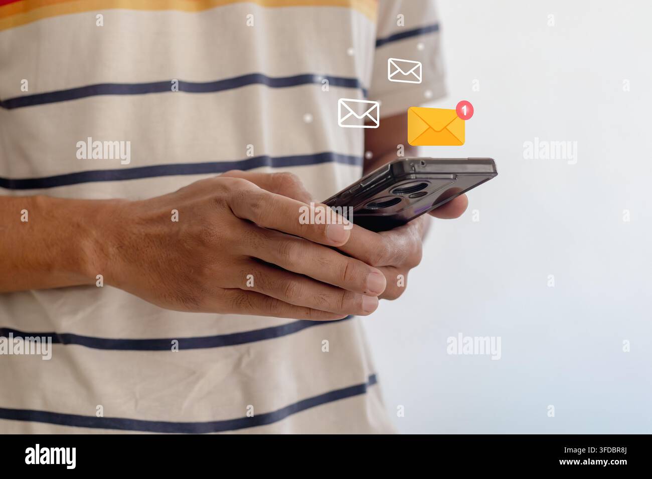 A man using a smartphone with digital email or message notification Stock Photo