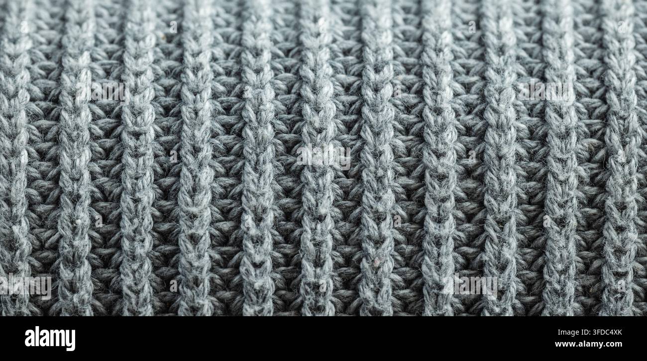 Grey knitted wool fabric showing a close-up texture and pattern Stock Photo