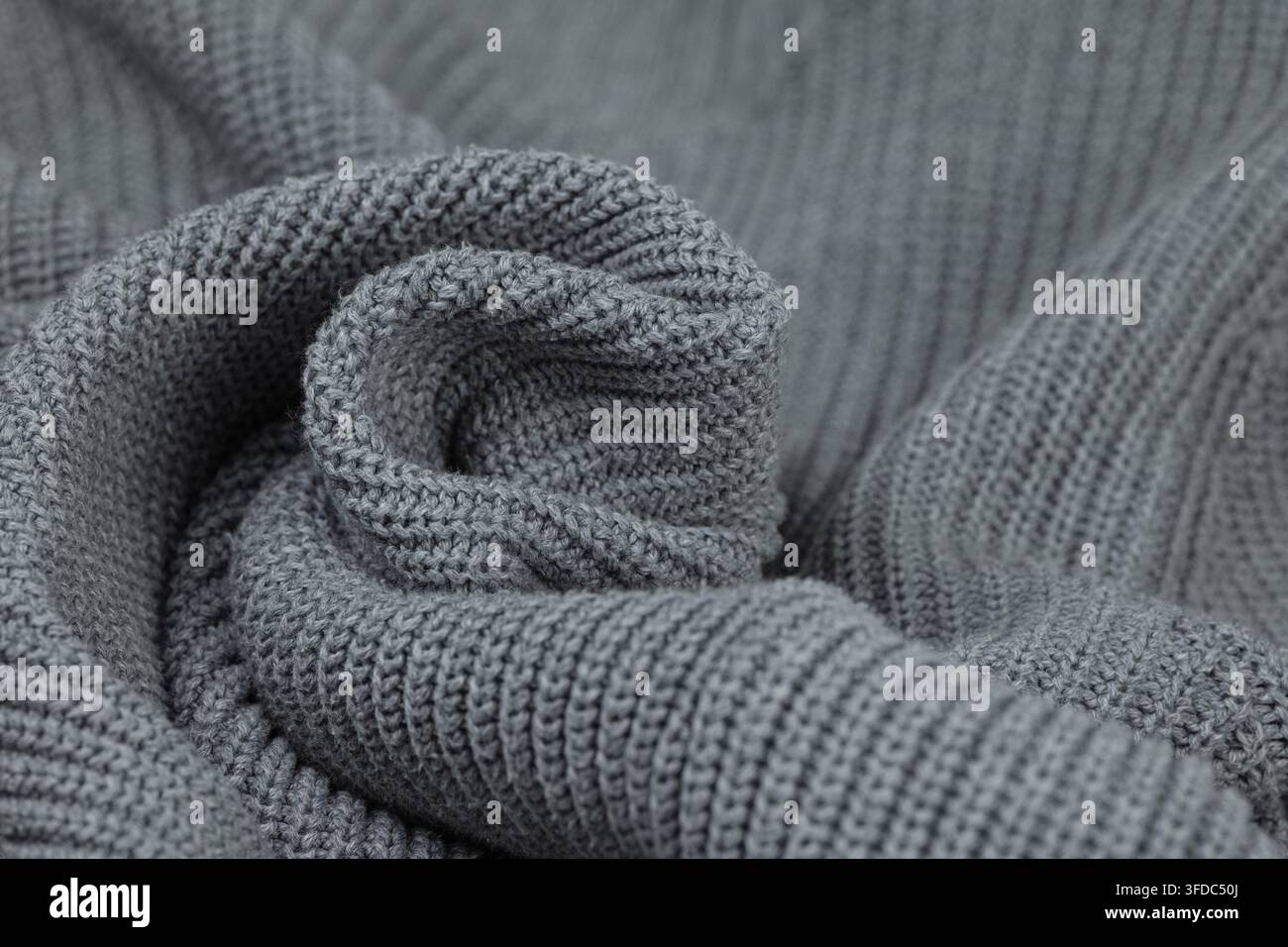 Grey knitted wool fabric showing a soft, warm texture pattern Stock Photo