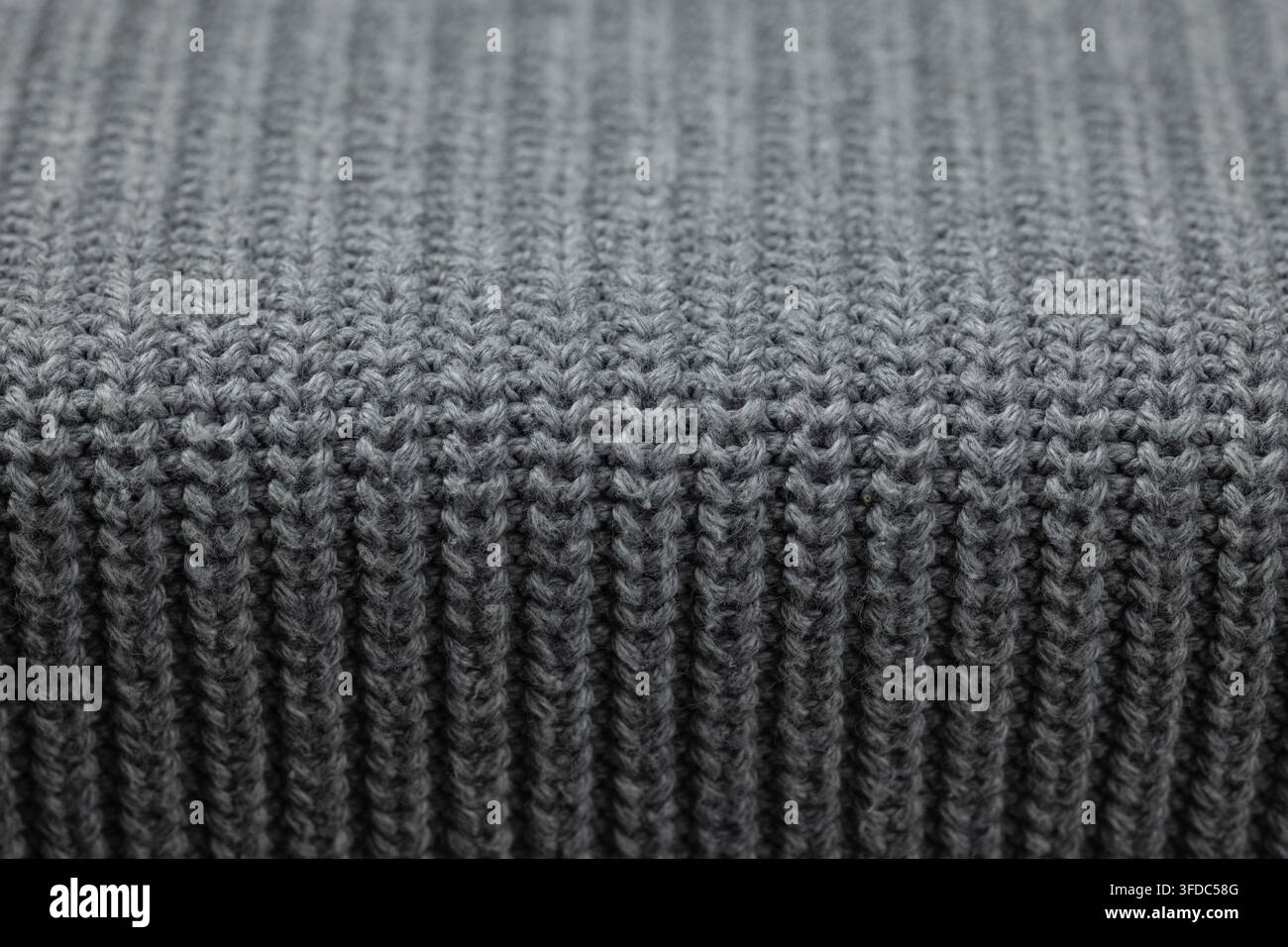 Gray knitted wool fabric showing a close-up texture background Stock Photo