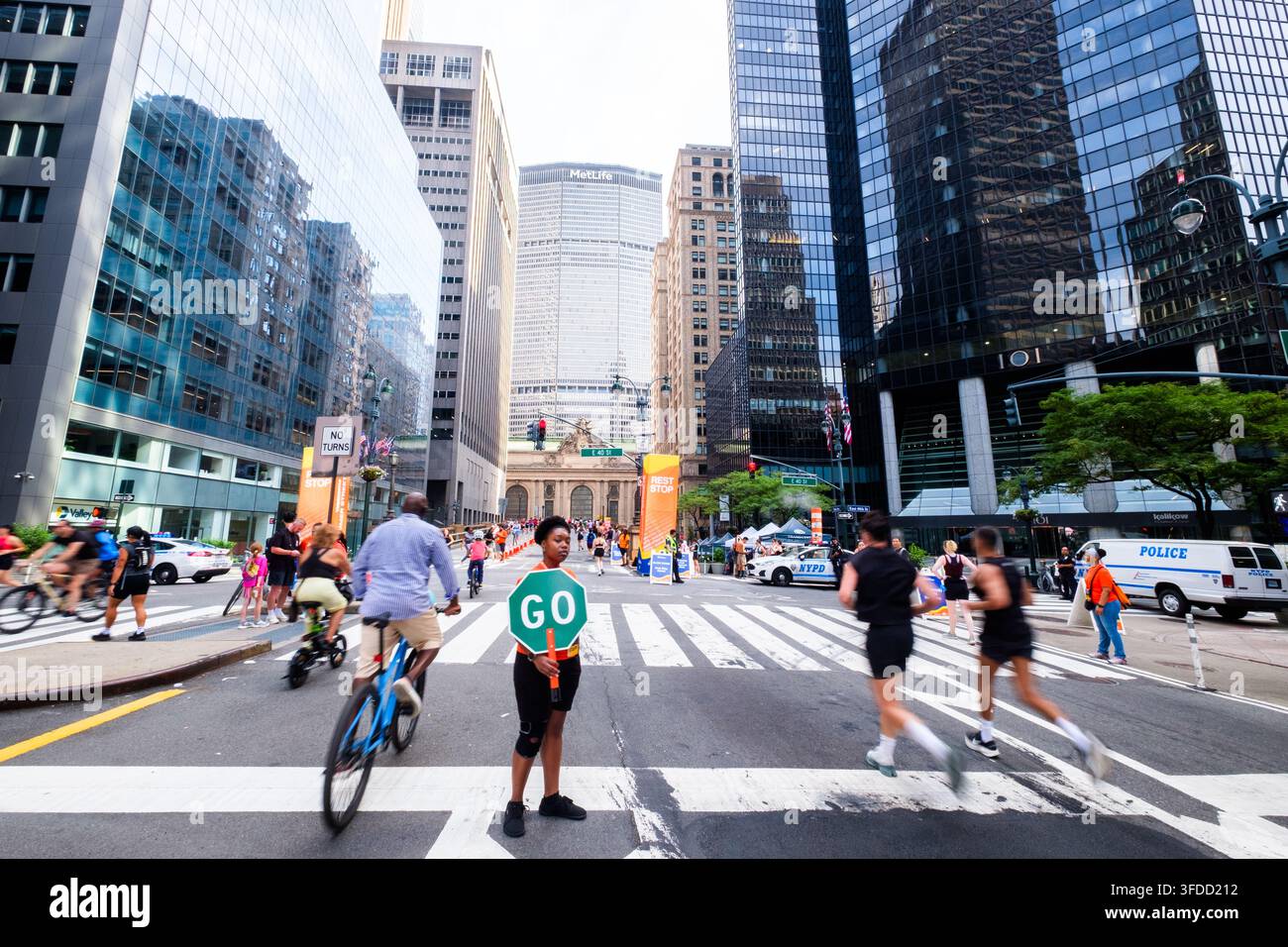 Pedestrians and cyclists on Park Avenue near Grand Central Station in Manhattan, New York City, during the Summer Streets closure of streets for recre Stock Photo
