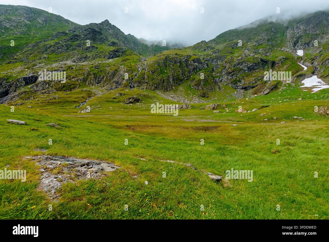 Romania mountain landscape in summer. scenic view of Fagaras ridge under overcast sky. rainy weather forecast background Stock Photo