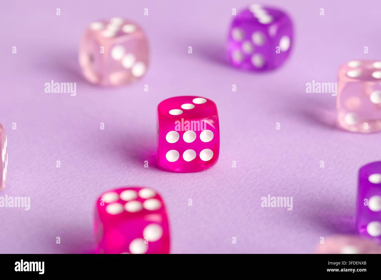 Different game dices on lilac background Stock Photo