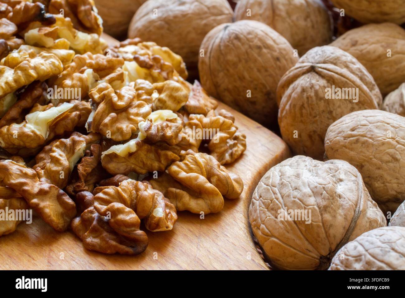 Walnuts and walnut kernels close-up. Composition of nuts. Selective focus. Stock Photo