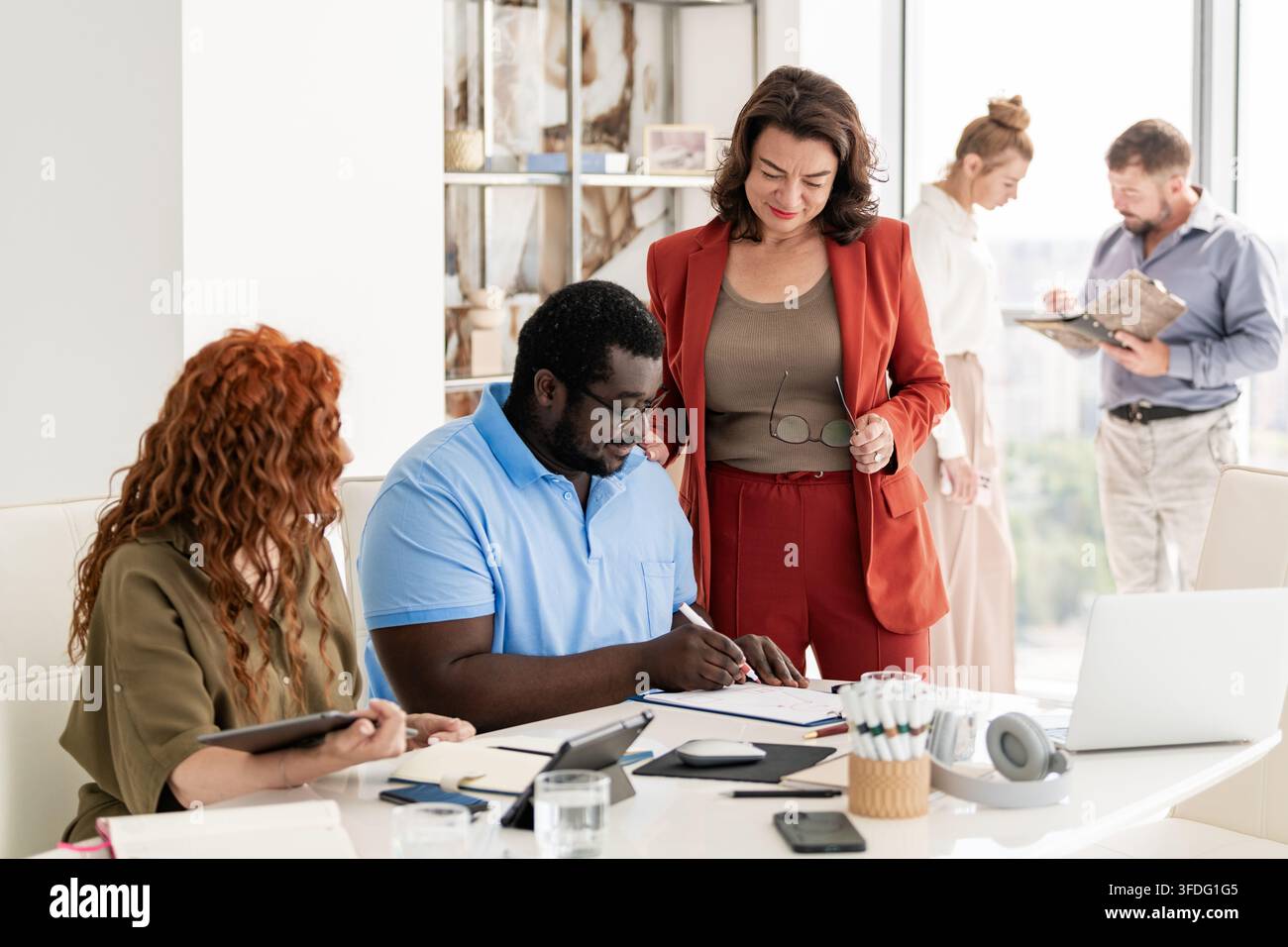Diverse colleagues collaborating on a project in an office Stock Photo