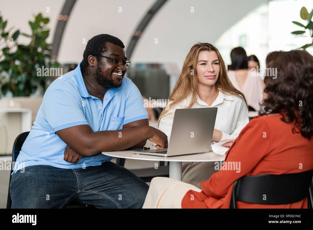 Diverse coworkers having a casual office lobby meeting Stock Photo