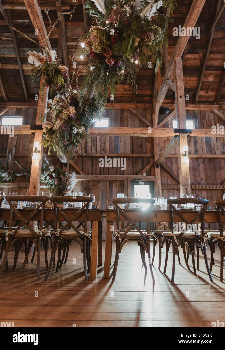 Rustic barn wedding reception with long tables Stock Photo