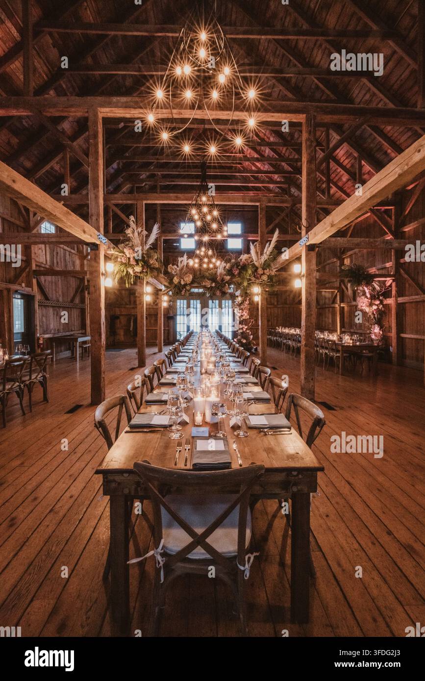 Long table set for rustic barn wedding reception Stock Photo