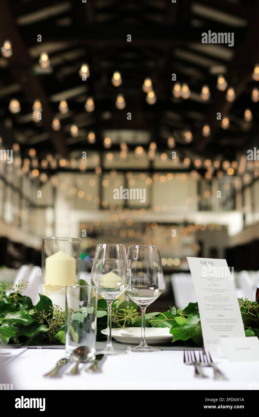 Elegant wedding reception table setting with greenery Stock Photo