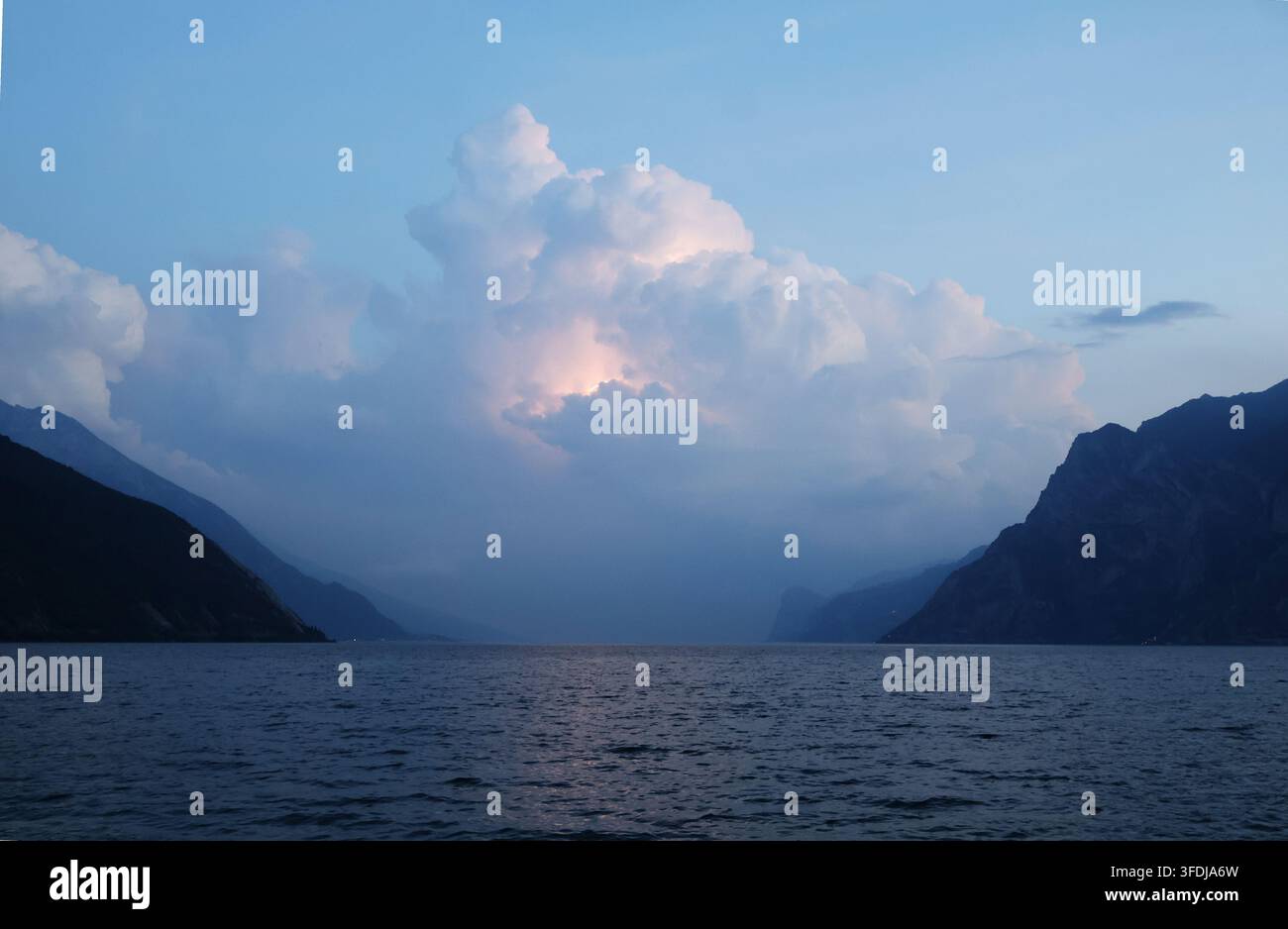 Dramatic storm clouds with lightning over Lake Garda, viewed from Torbole, Trentino, Italy. Stock Photo