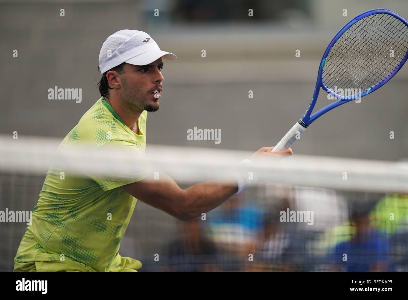 Jamie Faria, of Portugal, returns the ball during the first round of ...