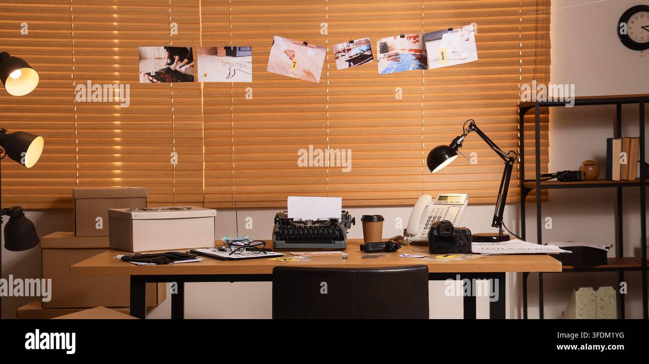 Criminal investigation and forensic analysis, detective office desk with evidence photos and typewriter for case report writing in a police station Stock Photo