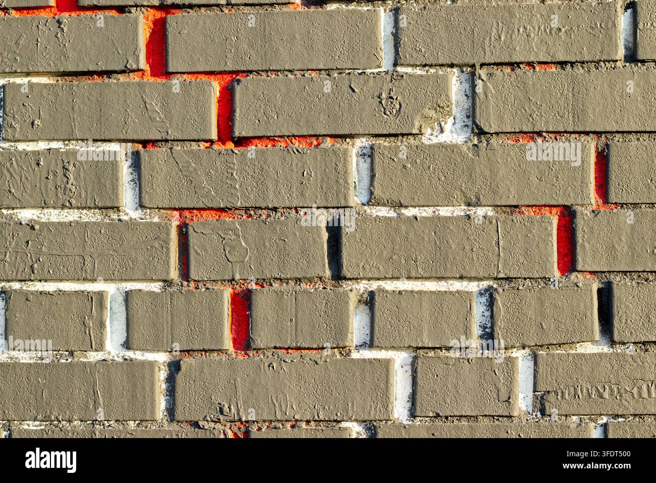 Plastered brick wall pattern with red gaps Stock Photo